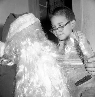 Santa's beard gets a tug at a Christmas party for city employees.