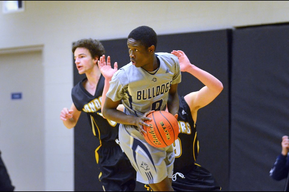 Byrne Creek's Abdul Bangura looks to pass during opening round action against the Duchess Park Condors on Wednesday at the B.C. 3-A senior boys provincial basketball championships in Langley.