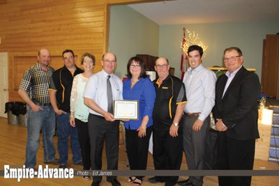 Receiving recognition from the RM of Wallace-Woodworth, representing the Tutthill family (l-r) Steven, Royden, Cyndi, Ken and Vicki (holding a certificate of appreciation), and Lynn Tutthill with municipal councillor for Ward 3 (Elkhorn) Clayton Canart and Reeve Denis Carter.