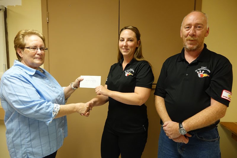 Deborah Smith, president of the Legion Ladies Auxiliary, left, presents a $2,000 donation to YBC pro