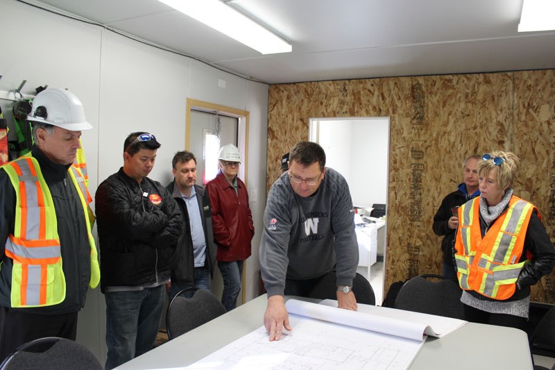 Stantec field representative Perry Piwniuk shows Thompson city council the blueprints for the new wastewater treatment plant.