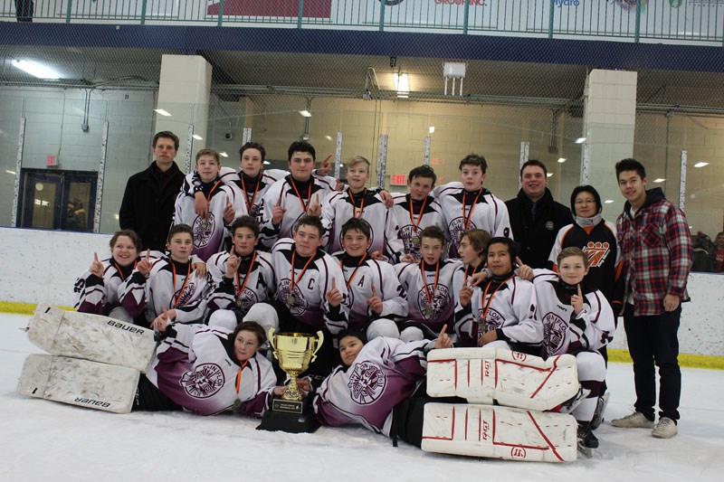 The Flin Flon Bombers celebrate winning the Dylan Cripps Memorial Cup on Sunday, Dec. 10. Dylan’s brother James Cripps, back row, right, and mother Li Cripps, back row, second from right, were also on hand to congratulate the team.