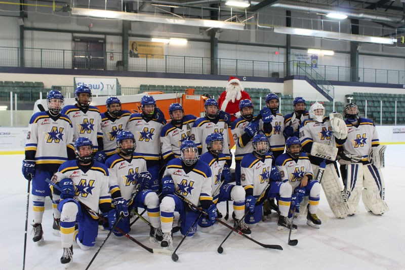 The Norman Northstars pose for a group photo with Santa Claus between the first and second period of their Dec. 15 contest against the Kenora Thistles.