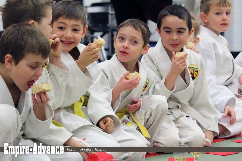 The Japanese ceremony gets more grins with Rice Krispie cake than with the more traditional rice cakes! (l-r) Judo students Conner Hancharyk, Brenden Houston, Corbin Hancharyk, Brock Dron, Caleb Wolfe, and Caleb Anderson. The Southwest Judo Club hosted the event Saturday Jan. 13 at Mary Montgomery School in Virden.