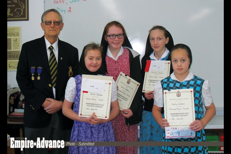 Ed Clayton, past president of Elkhorn Legion Br. 58, presented certificates to students at Plainview Colony School who were winners at the Zone 26 level (Birtle – Russell – Virden) of the Legion Poster Literary Contest.