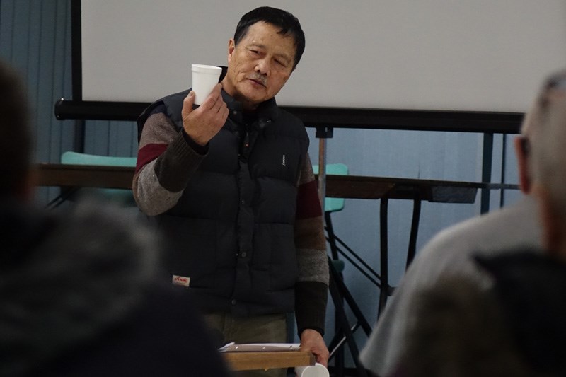 Thompson resident Chiew Chong employs a disposable coffee cup to make a point during his presentatio