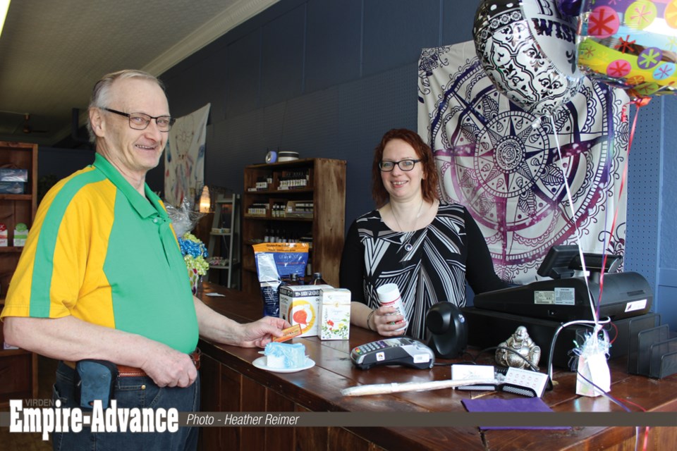Wesley Braybrook (l) was the first through the doors Saturday morning when Angie's Natural Health reopened for business.