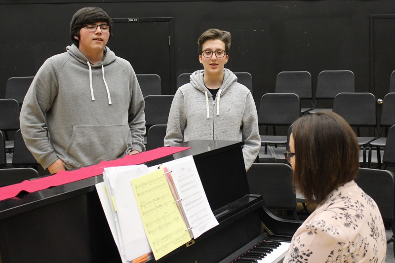 Mark Fortin, left, and Paige Kirby-McDougall, right, run through some choral exercises at the Letkem