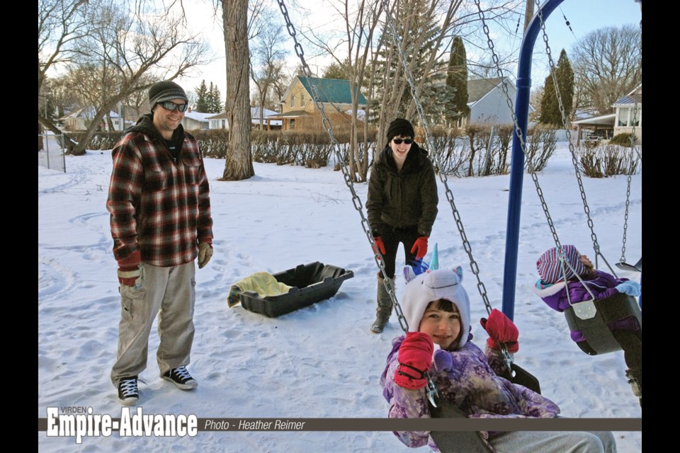 “Snow? What snow?” This Virden family loves the mild weather and the new swing set in Victoria Park. (l-r) Derek Plaisier, Meaghan Veysey, Sage and Rayne Plaisier.