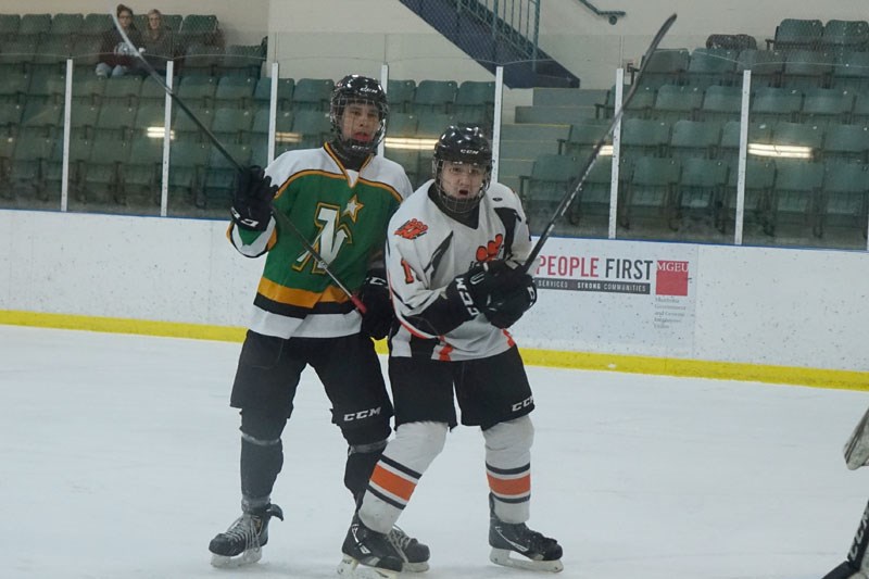 Drayden Spence, right, seen here in a midget AA playoff game against the Norway House North Stars in