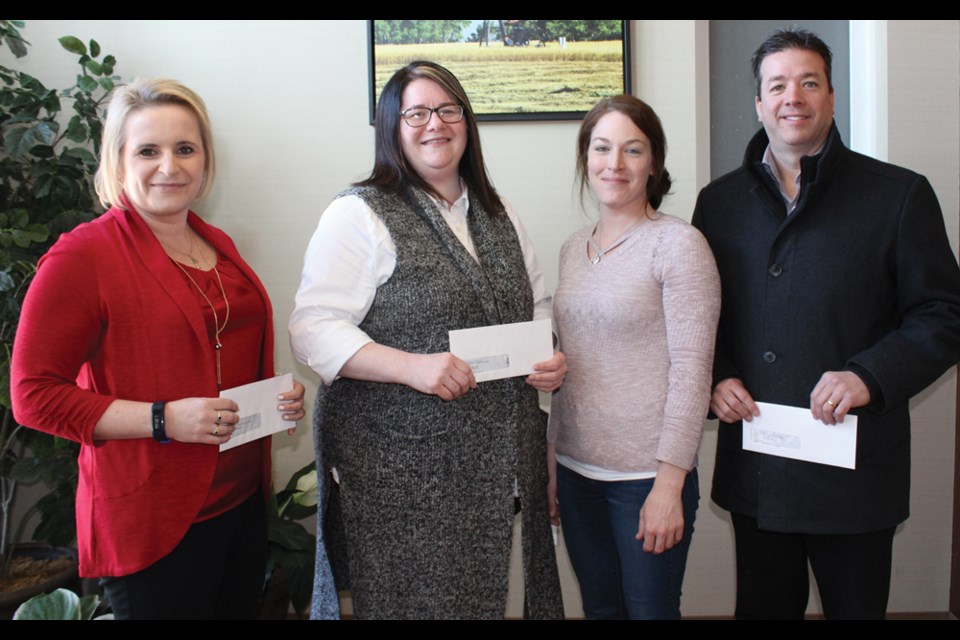 Receiving donations are (l-r) Cindy Cassils of Southwest Horizon School Division, Dana Barteaux, trustee with Park West School Division, Kelly More, chair of Tundra’s United Way committee, and Kent Reid of Fort la Bosse School Division.