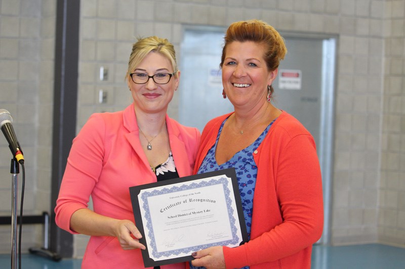 Co-superintendent Angèle Bartlett (right) accepts an award from University College of the North co-