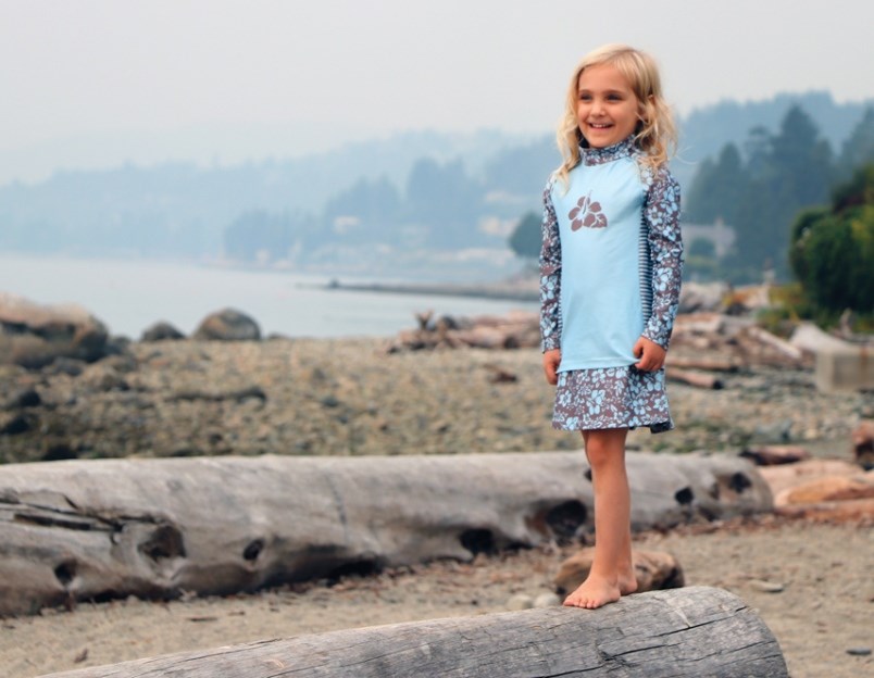 A young beach-goer sports a Hibiscus skort and shirt with built-in ultraviolet protection, part of a new sunwear line created by Ambleside-based Stonz children’s clothing company.