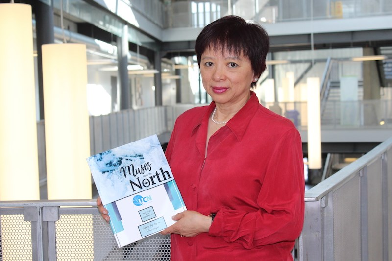 Professor Ying Kong poses for a photo with the very first issue of UCN’s student journal, Muses from the North, which debuted in the fall of 2017.