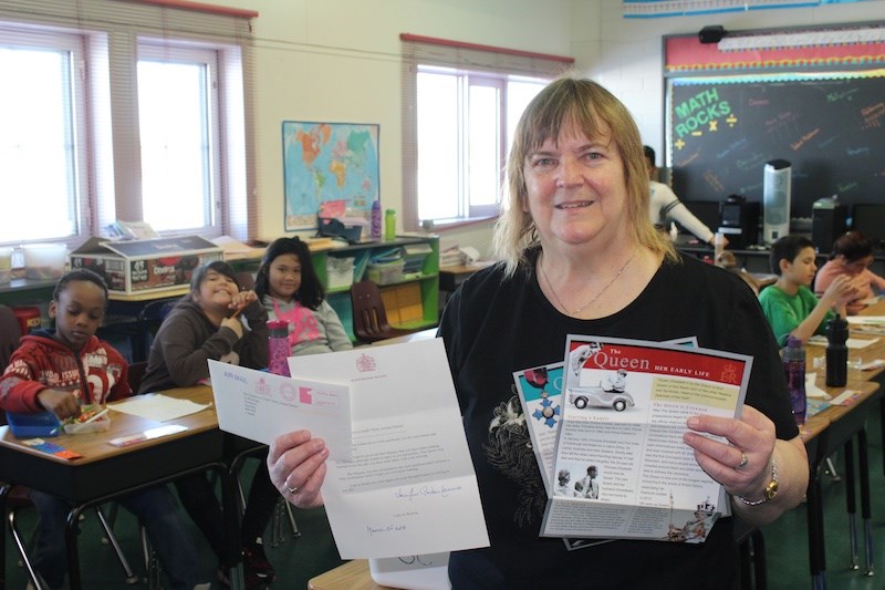 Juniper teacher Pat Pegus shows off the response letter her Grade 3 class received from Buckingham P