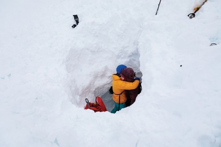 Maia Schumacher, left, hugs her friend, who has asked to remain anonymous, after she survied being buried under 3.5-metres of snow in an avalanche near Moraine Lake on April. 5.