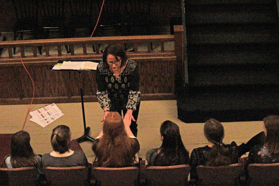 Piano Adjudicator April Gibson demonstrates technique for students competing in Intermediate piano classes on Wednesday. April 11.