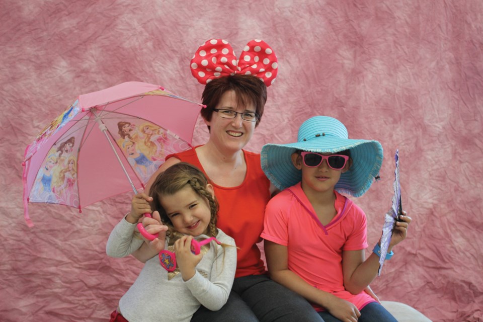 Twyla Robillard and her daughters Danika (4) and Taya (7) dressed up in costumes at the event’s photo station.