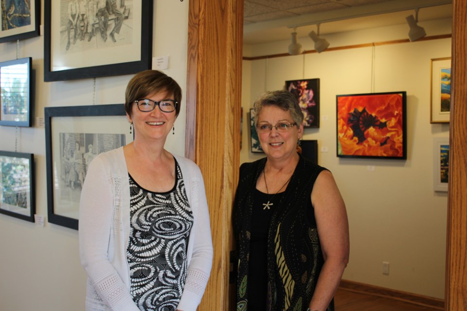 A tale of two artists: Jacqui Beckett (l) on her side of the Arts Mosaic gallery and Holly Dauvin on hers.
