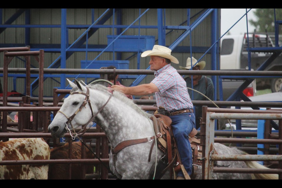 Lyle Brown on "Maggie focuses on the calf that's about to launch from the chute in the Annual Casey Brown Memorial Roping event, Saturday, June 16. Brown roped to a win for his son's memorial saddle.