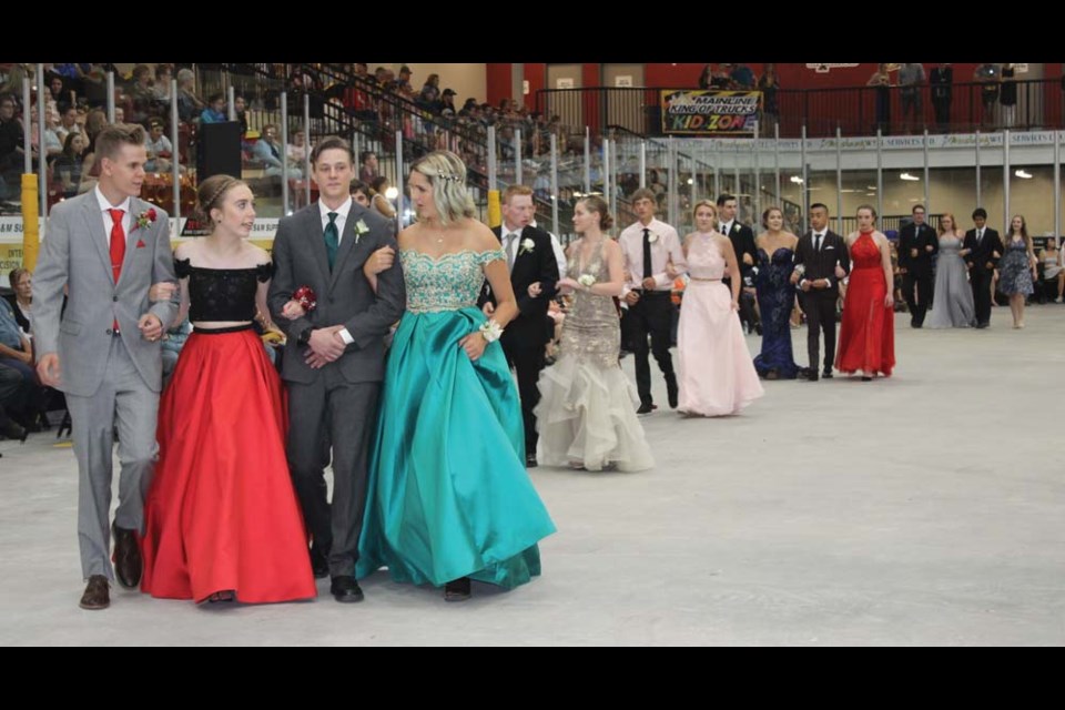 Freshly-minted graduates walking in Virden Collegiate’s grand march at TOGP Tuesday evening with proud parents watching from the wings.