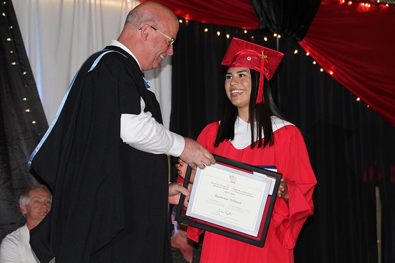 RDPC principal Rob Fisher hands graduate Ramona Pelland the Governor General’s Academic Medal during Wednesday’s graduation ceremony. Pelland received this award for achieving the highest average in her class. Photograph by KYLE DARBYSON.