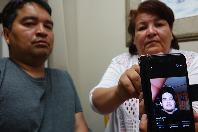 Tom Shaoullie, left, and Jeanette Shaoullie, right, with a cell phone photo of their son Russell Hyslop, 26, who hasn’t been since June 19 in Thompson.