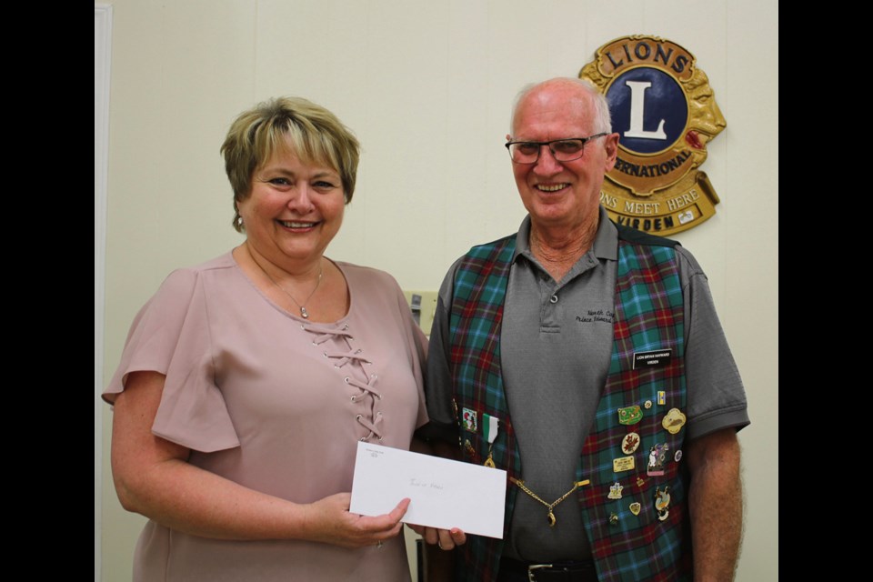 Virden Lions, represented by Lion President Brian Hayward, presenting Virden Main Street Boost project committee member Paula Bazil with a $5,000 cheque toward the purchase of outdoor benches for Seventh Ave. downtown.