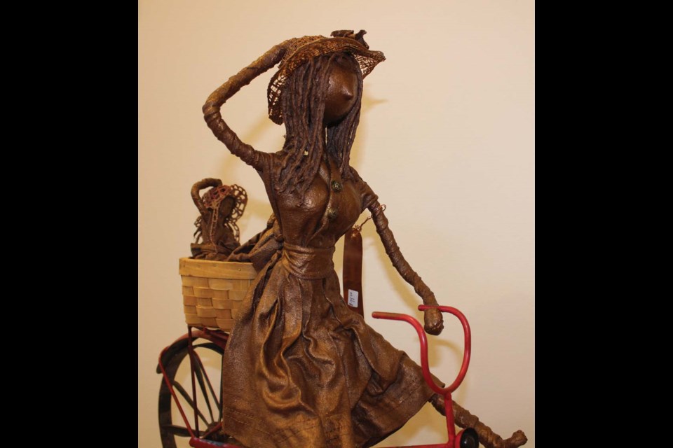 Dianna creates Paverpol sculptures like this bicycle, rider and passenger. Paverpol artists often incorporate fabric, lace and props for special effects.