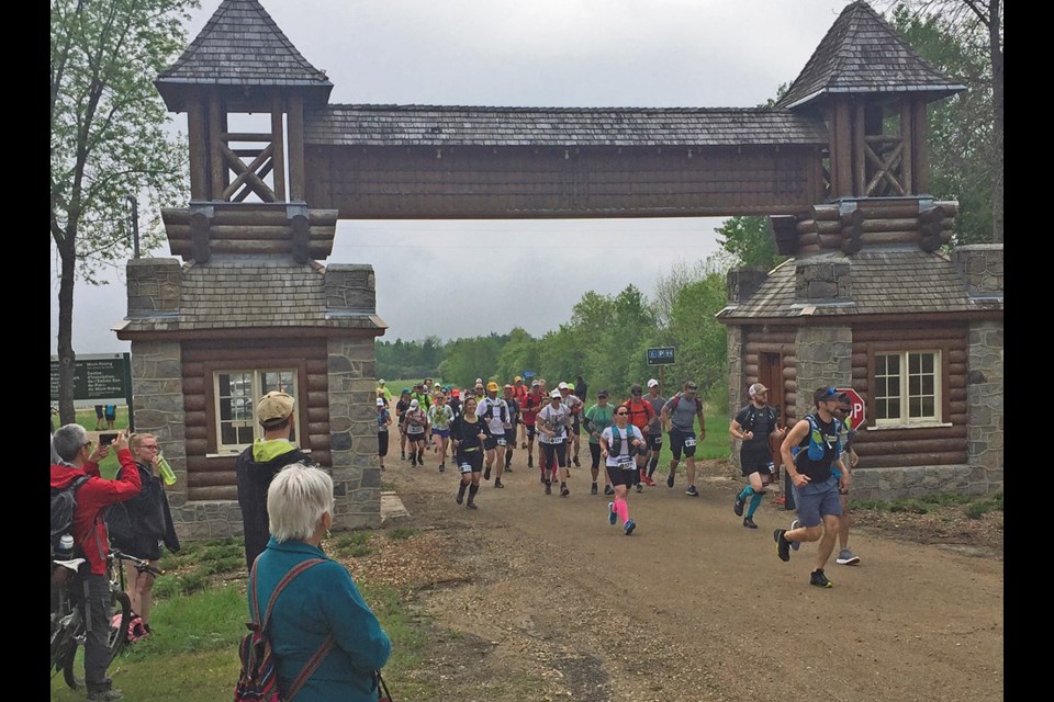 Runners, Oak Lake's Branum among them, racing to the East Gate finish line in the marathon in June, 2018 at Riding Mountain.
