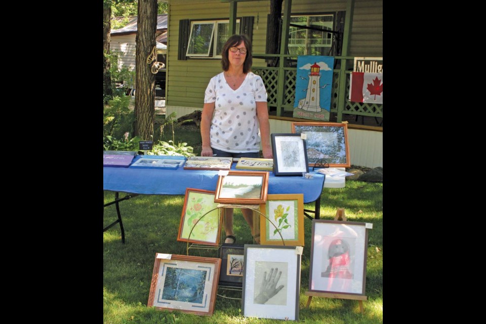 Lynda Denbow of Oak Lake Beach shows work for sale at last year’s Art Walk.