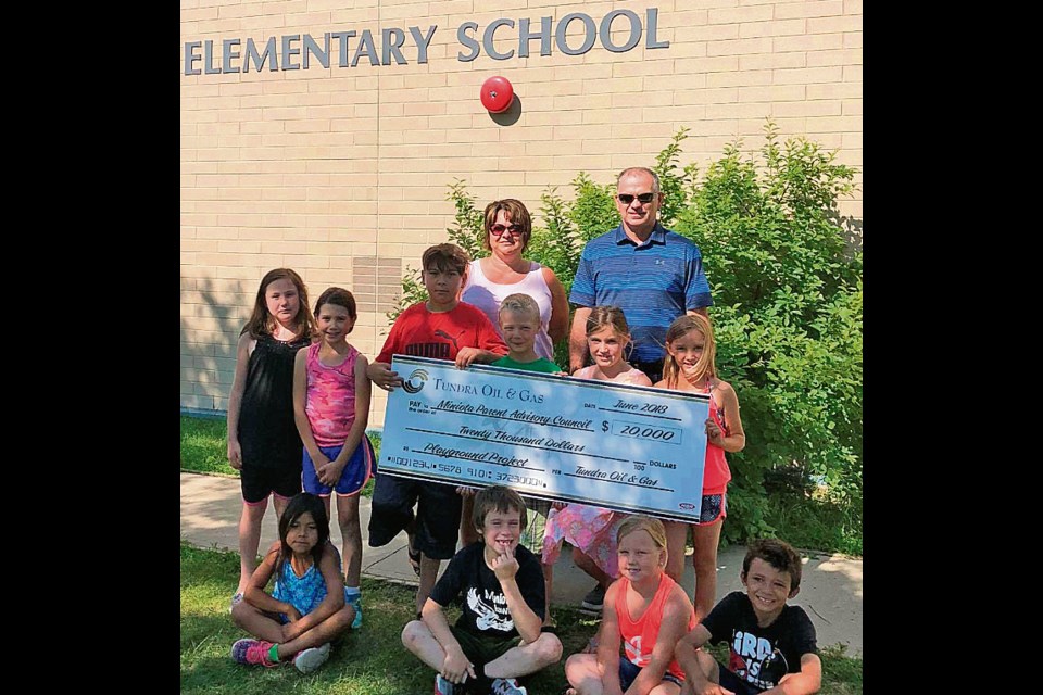 Tundra Oil & Gas (through the Richardson Foundation) recently donated $20,000 to the Miniota Parent Advisory Council for the Miniota School playground. Jason Lewis (TOG Surface Land Rep) is presenting the cheque to PAC member Carolin Thompson (left rear) and some students from Miniota School. This donation will help with playground improvements.