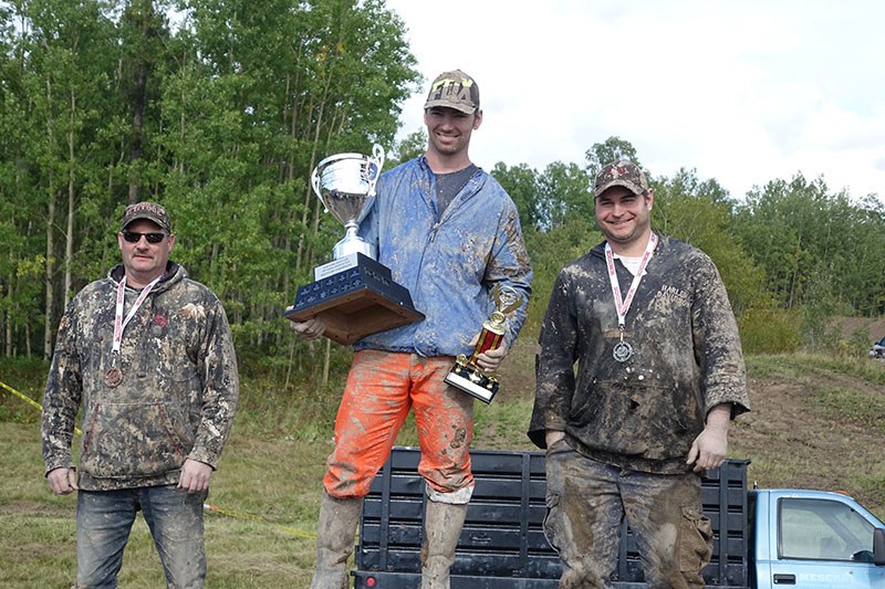 Kenneth Wark, centre, and in his truck, beat Kelly Kopeechuk , right, and Greg Robson, left, to win the modified eight-cylinder truck class at the 2018 Thompson mud bogs Sept. 2. Wark also won the open truck class, in which he was the only competitor to make it out of the pit unassisted.