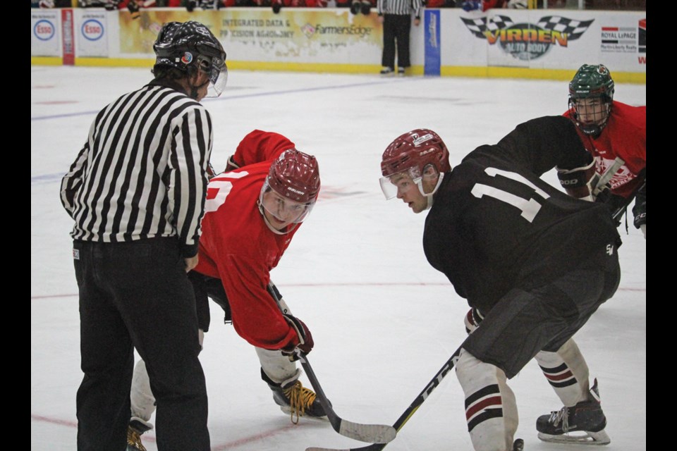 Players face off in one of the many puck drops over the long weekend hockey camp.