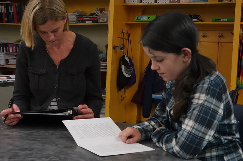 Deerwood School Grade 5 teacher Robyn Caldwell, left, and student Hallie Eveleigh, right, during a r