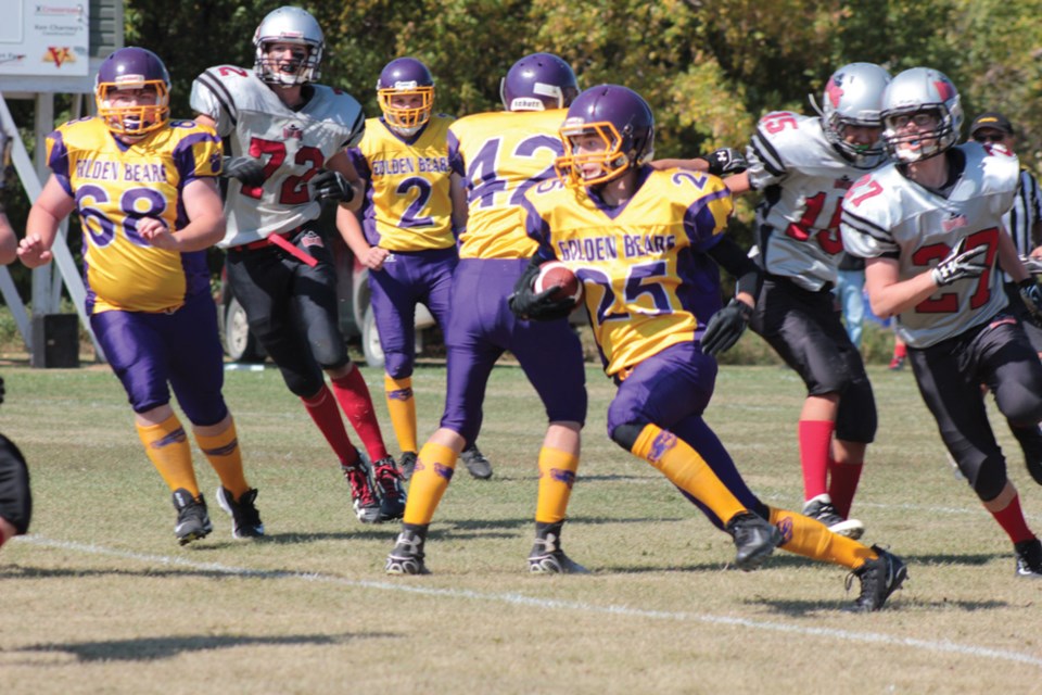 The VCI purple and gold dominated the Parkwest Outlaws in last Friday’s Tundra Bowl. Nic Smith (25) runs the ball delivered by quarterback Paul Winters (2).