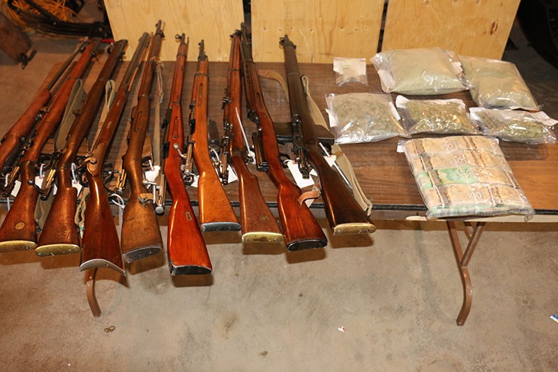 A man faces nine charges after Flin Flon RCMP seized a dozen guns and more than nine kilograms of marijuana and marijuana-infused products in a Sept. 26 raid.