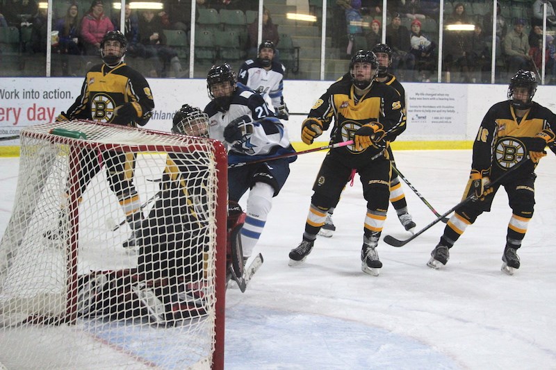 Forward Keistin Saunders (centre) shoots the puck wide of the Winnipeg Bruins’ net during the Norman Northstars’ 2018−19 home opener at the C.A. Nesbitt Arena.
