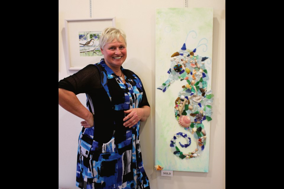 Barb Widger created this watercolour seahorse adorned with sea glass pieces from around the world, including the first shell she received on the 800 km hike - Camino de Santiago.