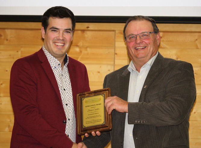 Former Reeve of RM of Wallace-Woodworth Denis Carter of Kenton receives a plaque of recognition from the municipality from Reeve Clayton Canart.