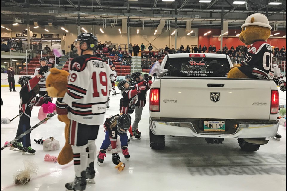 One of the many places where cheer begins – Teddy Bear Toss at an Oil Caps game with dozens of stuffies destined for hampers.