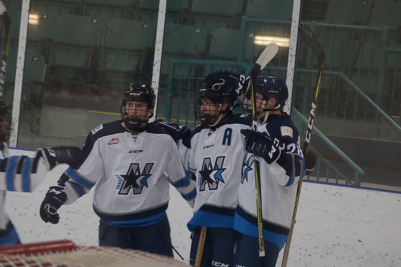Norman Northstars Jamie Valentino, right, and Henry Muchikekwanape, centre, celebrate after teaming