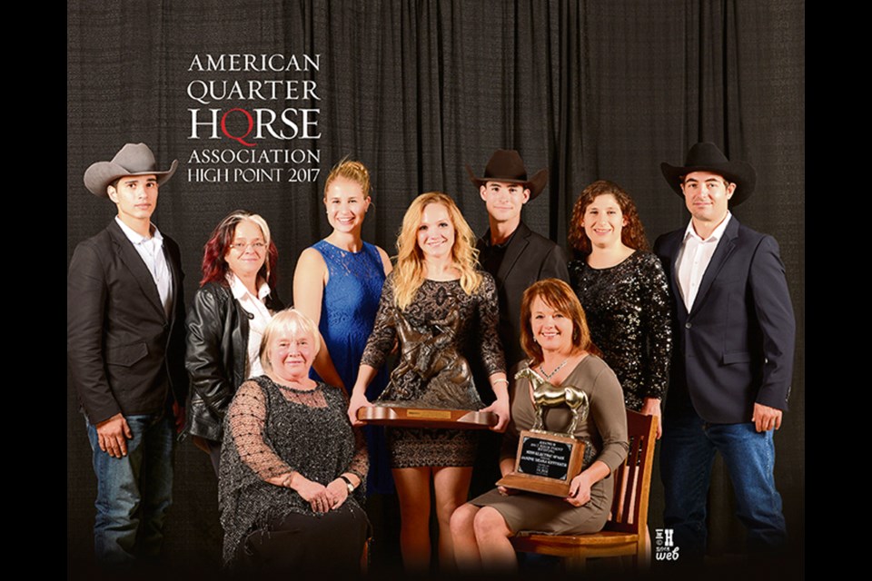 Nov. 11, 2018, Janine Ketterer (centre) holding a large plaque, with grandmother Sherald Joynt (front l) and mother Laura Ketterer (holding trophy) at the AQHA awards banquet in Oklahoma City where Ketterer Janine received highpoint amateur reining award.