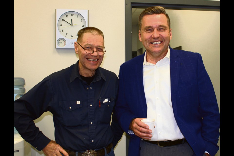 Charlie Main (l) of Virden shares a laugh with Doyle Piwniuk last Thursday at the MLA’s open house at his Nelson St. headquarters.