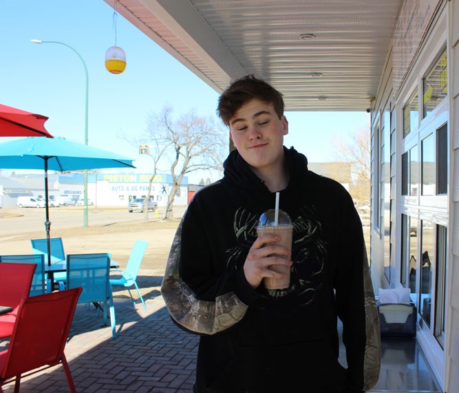 One of the ice cream store's first customers on March 22, Jayden looks pleased with his afternoon purchase.