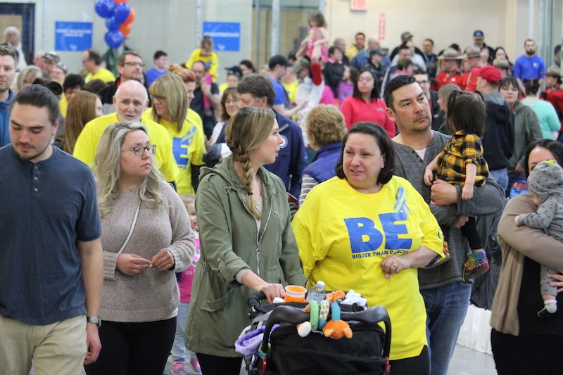 Northern cancer survivors (in yellow) and their family members complete the opening laps of the 2019 Thompson Relay for Life April 13.