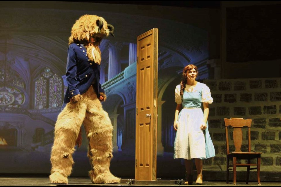 The Beast (Julian Berg) and Belle (Kennedy Charles) don’t hit it off… at first.