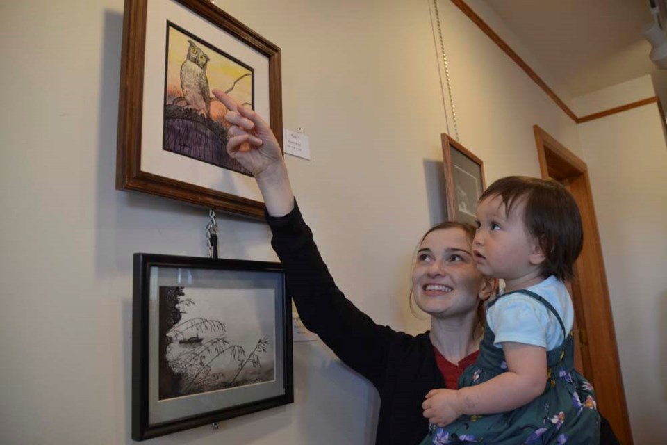 Eighteen-month-old Hazel is seeing her grandmother Hazel Kilford’s art for the first time. She and her mom, Laura Haya, are visiting Kilford in Virden from their home in Ottawa. Kilford is a member of the Virden Art Club, which is displaying its members' work all this month at Arts Mosaic.
