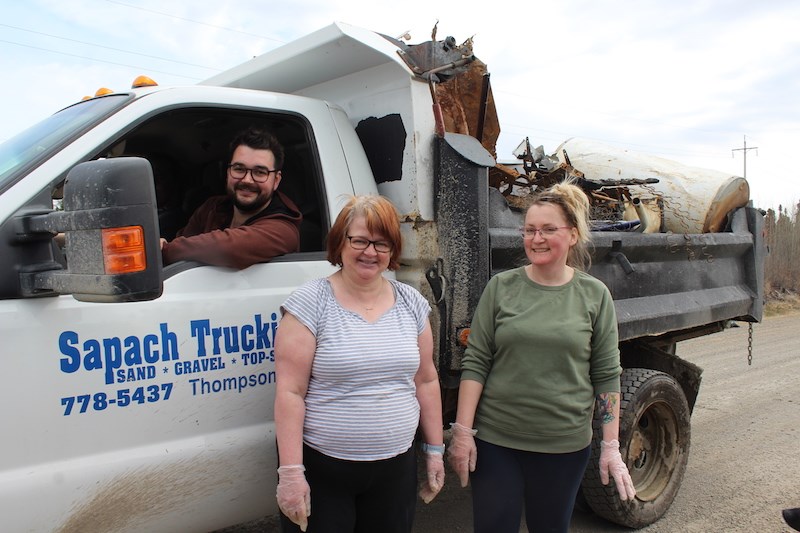 From left to right, city Thompson Coun. Andre Proulx, Brenda Sheppard and Dora Brenton take a short break from their May 11 cleanup of Jonas Road.