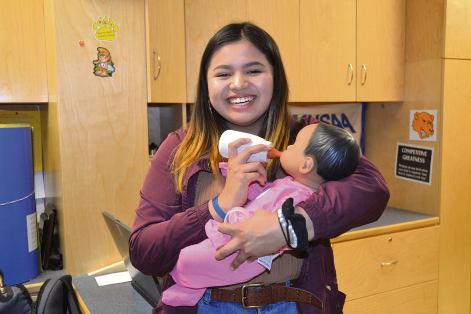 Jolei Cuny, a Grade 10 student at Virden Collegiate, is getting ready to take a baby “simulator” home for the weekend. As part of her Family Studies course, Jolei will spend 72 hours looking after a doll that cries, eats, dirties her diaper, and reacts to her care. VCI’s Family Studies curriculum prepares students for family life and further study in child care.